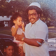 My father, David, holding me while my mother and sister look on.